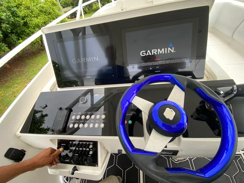 Slide: The Image of Helm of 2008 Intrepid 390 Sport Yacht with Garmin displays and blue steering wheel. - 31