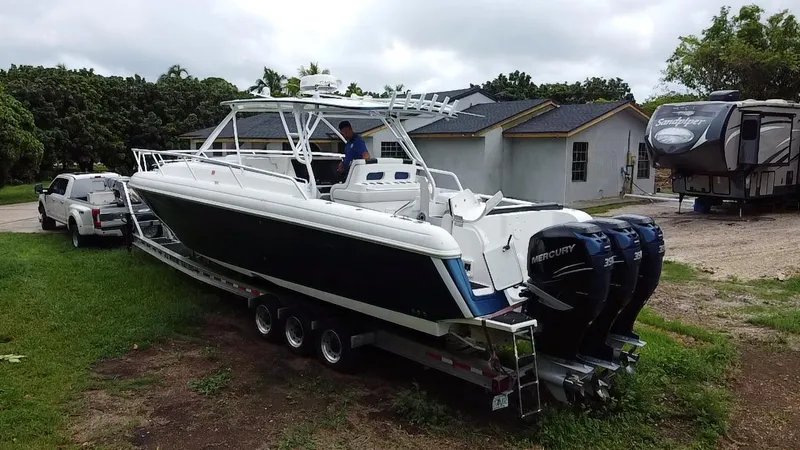 Slide: The Image of 2008 Intrepid 390 Sport Yacht on trailer, parked near a house and RV. - 35