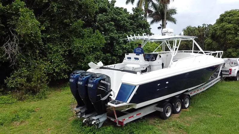 Slide: The Image of 2008 Intrepid 390 Sport Yacht on trailer, surrounded by lush greenery. - 36