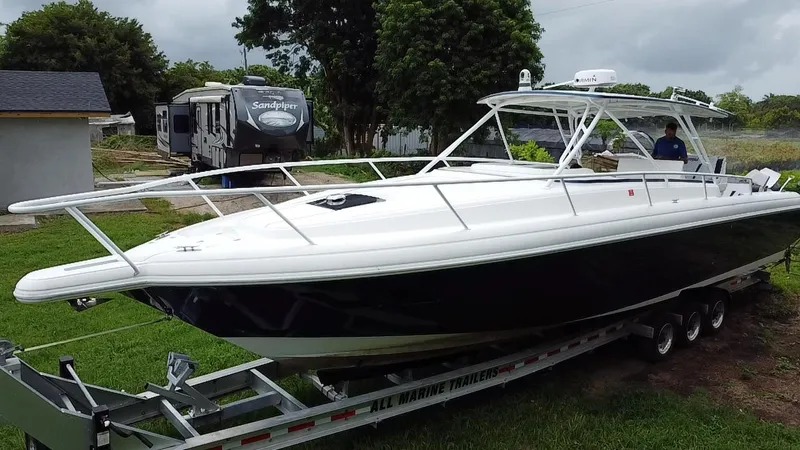 Slide: The Image of 2008 Intrepid 390 Sport Yacht on trailer, parked outdoors near trees and RV. - 4