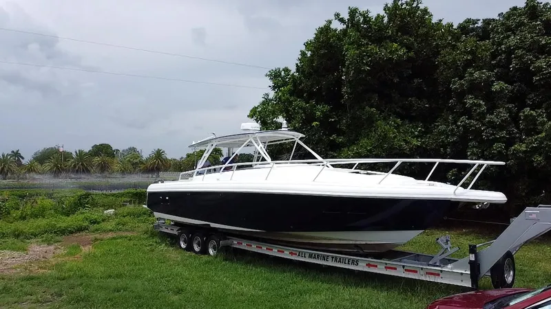 Slide: The Image of 2008 Intrepid 390 Sport Yacht on trailer, parked on grass near trees. - 5