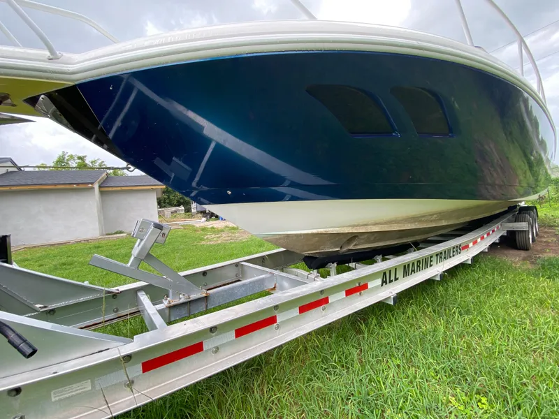 Slide: The Image of 2008 Intrepid 390 Sport Yacht on trailer, side view, outdoors. - 7