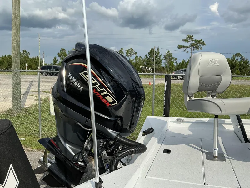 Slide: The Image of 2026 Xpress Hyper-Lift H22B boat with Yamaha VMAX engine, parked outdoors. - 11