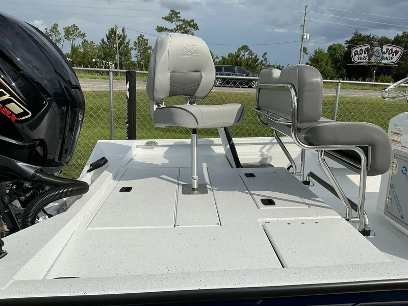 Slide: The Image of 2026 Xpress Hyper-Lift Series H22B boat with seating and motor, outdoors. - 12