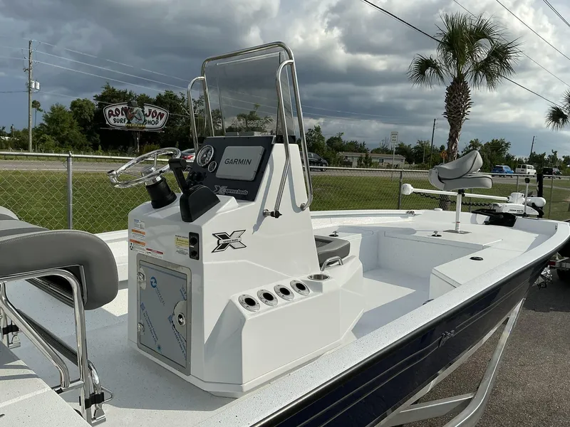 Slide: The Image of 2026 Xpress Hyper-Lift Series H22B boat with Garmin system, parked outdoors. - 13