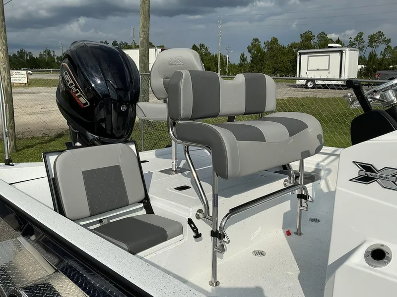 Slide: The Image of 2026 Xpress Hyper-Lift Series H22B boat interior with seating and motor. - 5