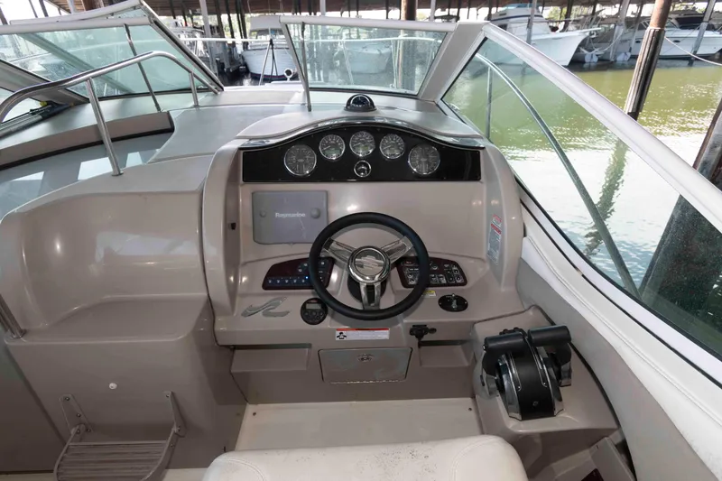 Slide: The Image of 2006 Sea Ray 290 Sundancer helm with steering wheel and control panel. - 3