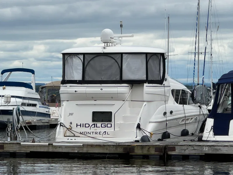 The Image of 2004 Sea Ray 390 Motoryacht docked in marina, overcast sky. - 1