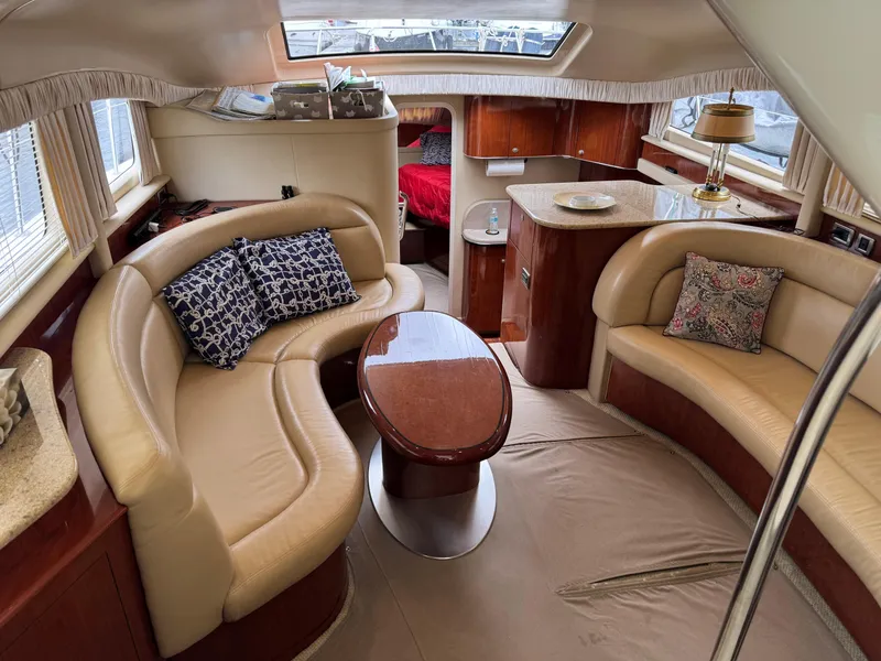 Slide: The Image of Luxurious interior of 2004 Sea Ray 390 Motoryacht with elegant seating and wooden finishes. - 12