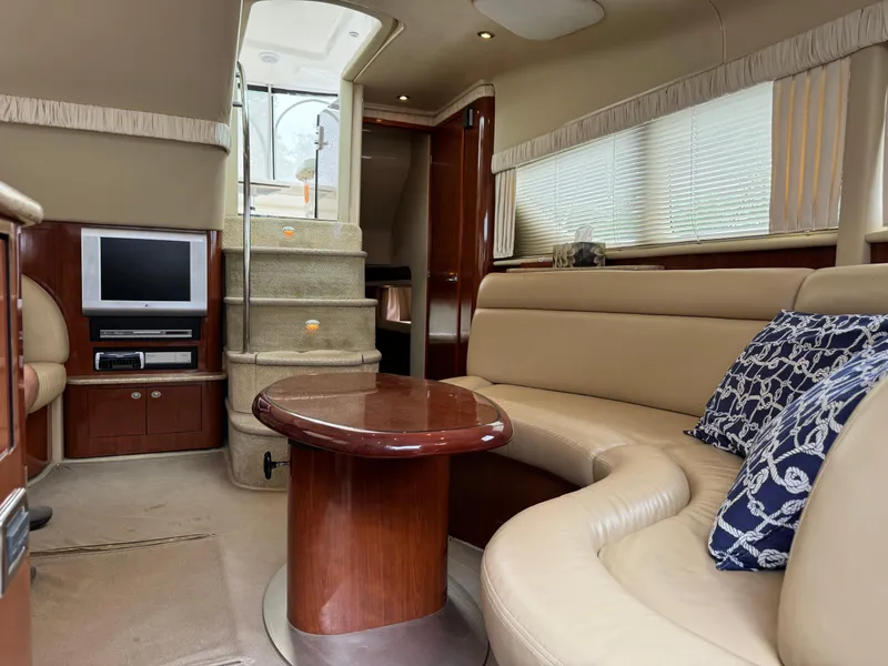 Slide: The Image of Interior of 2004 Sea Ray 390 Motoryacht with plush seating and entertainment system. - 17