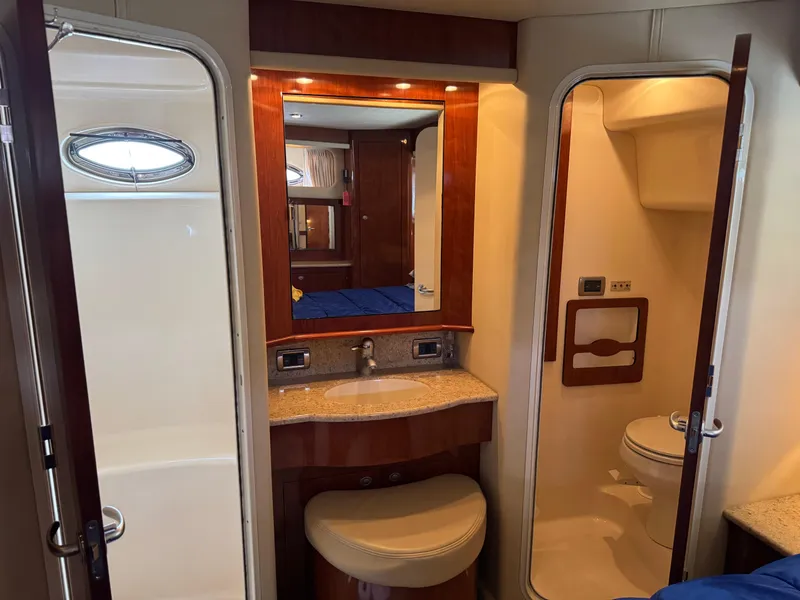 Slide: The Image of 2004 Sea Ray 390 Motoryacht bathroom with sink, mirror, and toilet. Luxurious marine interior design. - 22