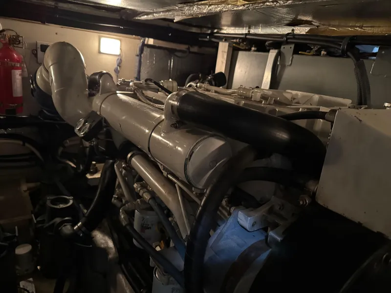 Slide: The Image of Engine room of 2004 Sea Ray 390 Motoryacht, featuring complex machinery and piping. - 23