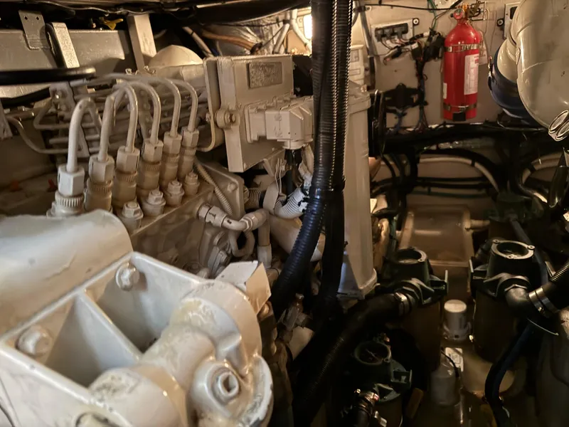 Slide: The Image of Engine room of 2004 Sea Ray 390 Motoryacht with visible components and fire extinguisher. - 24