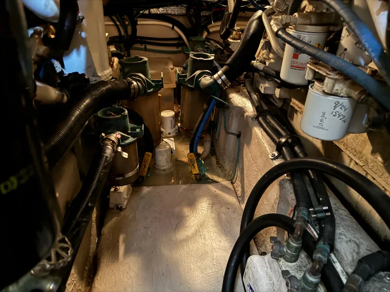 Slide: The Image of Engine room of 2004 Sea Ray 390 Motoryacht with hoses and filters visible. - 25