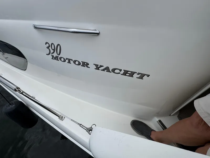 Slide: The Image of 2004 Sea Ray 390 Motoryacht exterior with visible branding and docked position. - 30