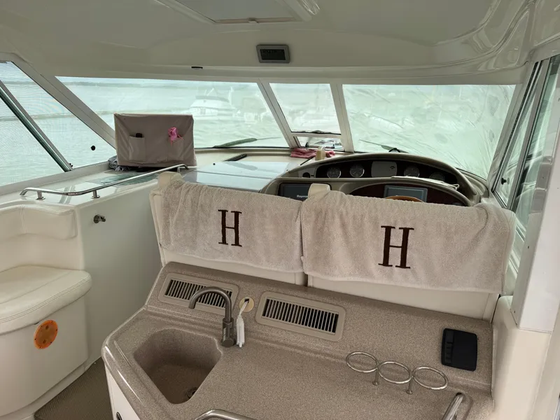 Slide: The Image of 2004 Sea Ray 390 Motoryacht helm with sink and monogrammed towels. - 5
