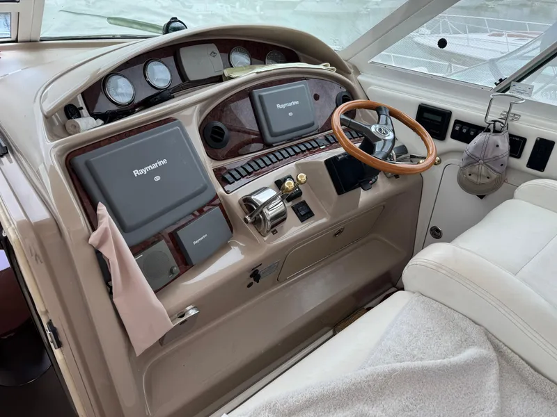 Slide: The Image of 2004 Sea Ray 390 Motoryacht helm with Raymarine navigation system and wooden steering wheel. - 8