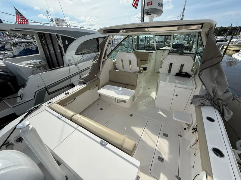 Slide: The Image of 2017 Pursuit DC 325 Dual Console boat interior with seating and storage compartments. - 17