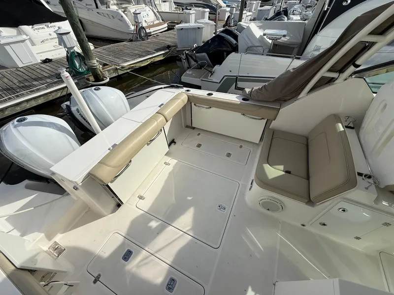 Slide: The Image of 2017 Pursuit DC 325 Dual Console boat interior with sink and storage compartments. - 26