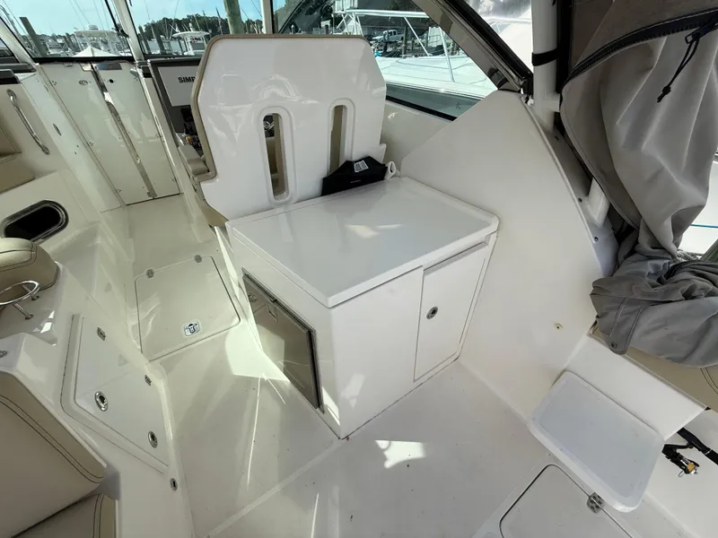 Slide: The Image of 2017 Pursuit DC 325 Dual Console interior with beige seating and modern design. - 28