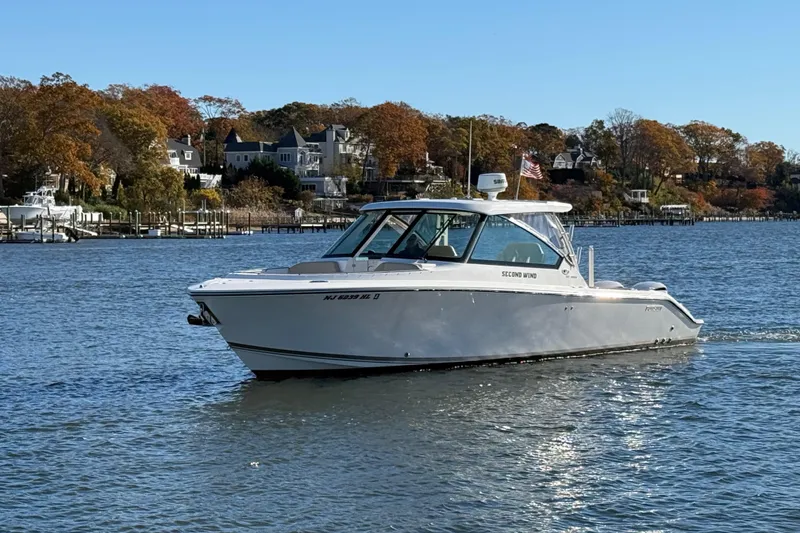 Slide: The Image of 2017 Pursuit DC 325 Dual Console boat cruising on a scenic lake. - 3