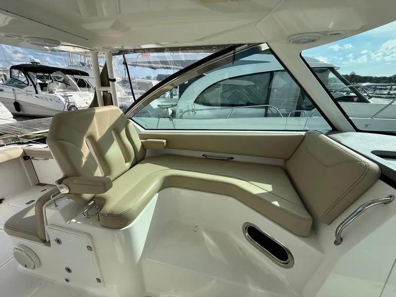 Slide: The Image of 2017 Pursuit DC 325 Dual Console boat interior with helm seat and steering wheel. - 31