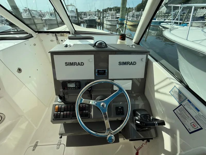 Slide: The Image of Joystick control on 2017 Pursuit DC 325 Dual Console boat dashboard. - 34