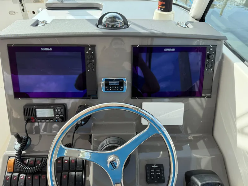 Slide: The Image of 2017 Pursuit DC 325 Dual Console boat interior with helm and seating area. - 37