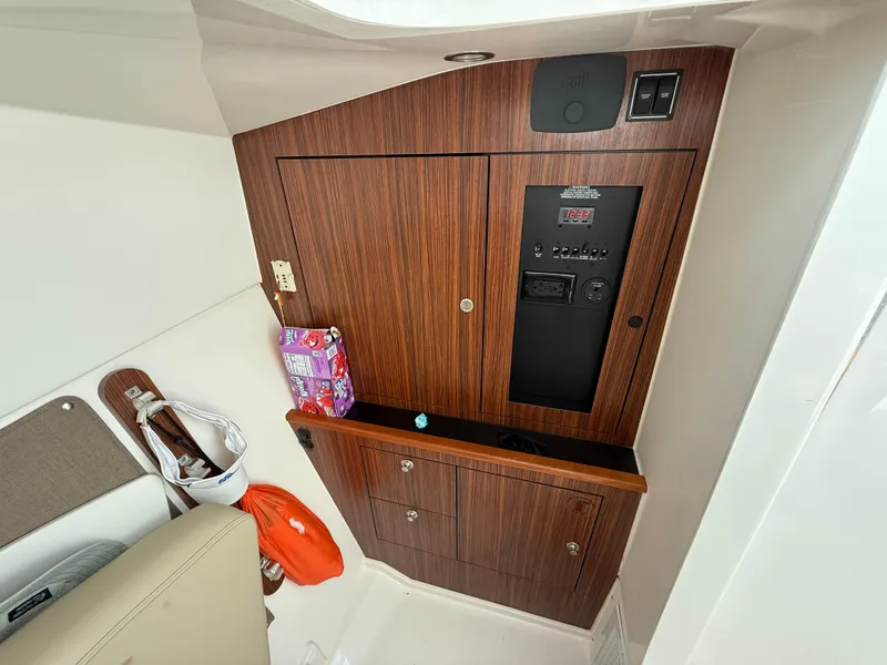 Slide: The Image of 2017 Pursuit DC 325 Dual Console boat interior with sink and storage. - 42