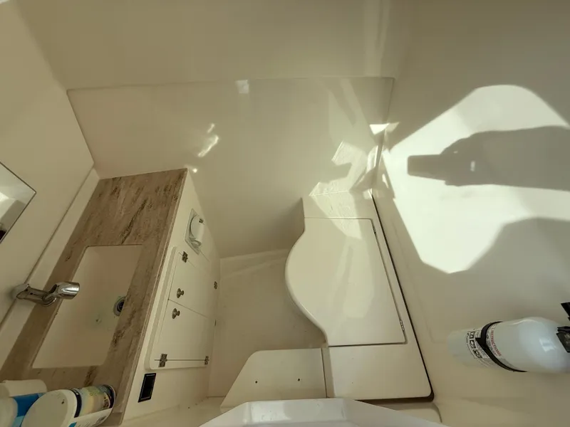 Slide: The Image of 2017 Pursuit DC 325 Dual Console boat docked in marina, featuring spacious seating area. - 44