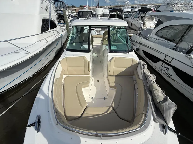 Slide: The Image of Anchor compartment of 2017 Pursuit DC 325 Dual Console boat, featuring chain and controls. - 48