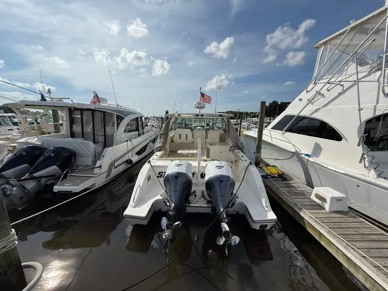Slide: The Image of 2017 Pursuit DC 325 Dual Console boat docked with twin Yamaha 300 HP engines. - 9