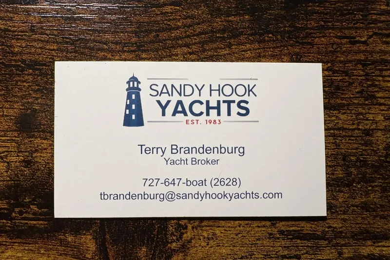 Slide: The Image of Business card for Sandy Hook Yachts, featuring yacht broker contact details. - 29