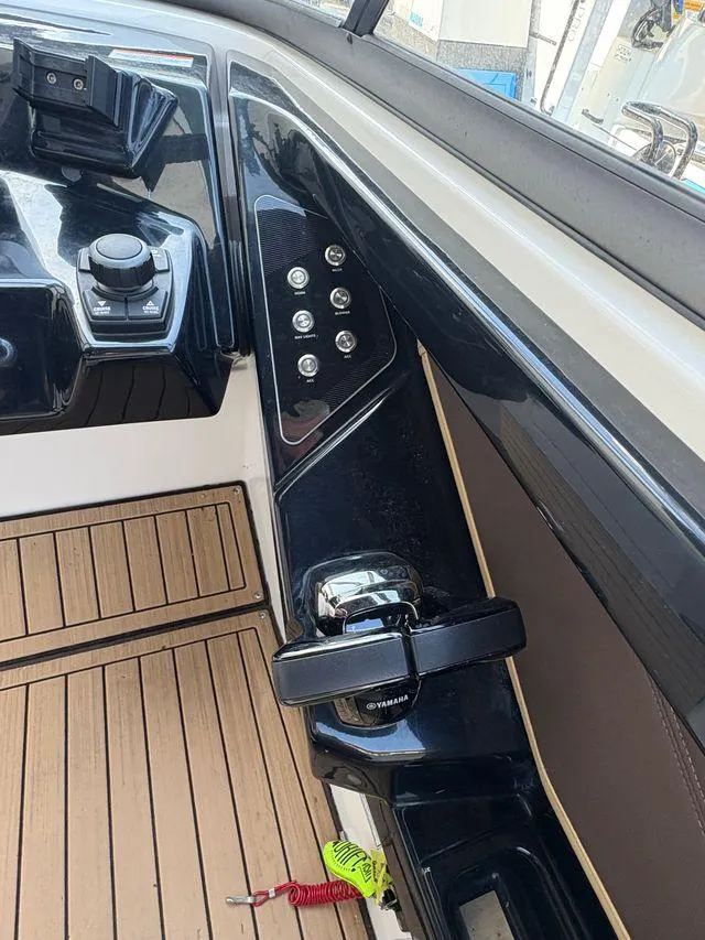 Slide: The Image of Yamaha Boats 2021 252SE dashboard with controls and wooden flooring. - 8