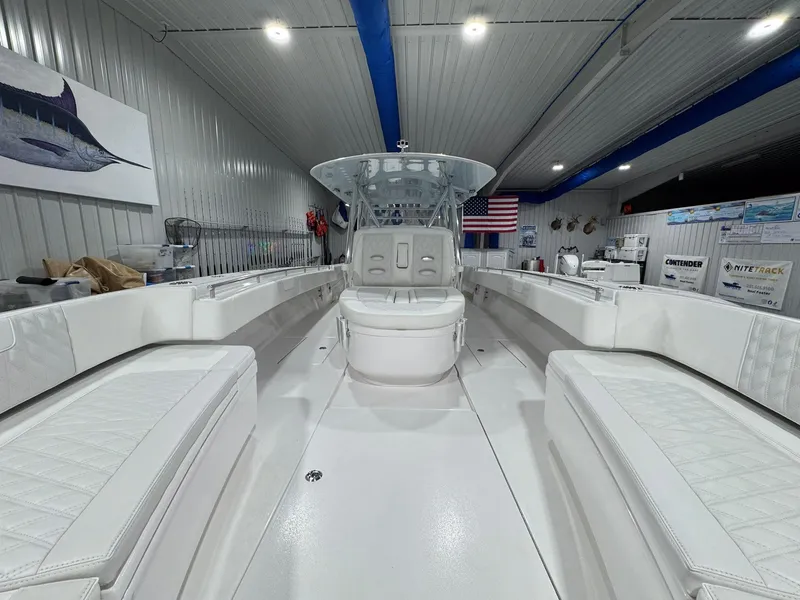 Slide: The Image of 2024 Contender 44 ST boat interior with white seating, in a well-lit showroom. - 11