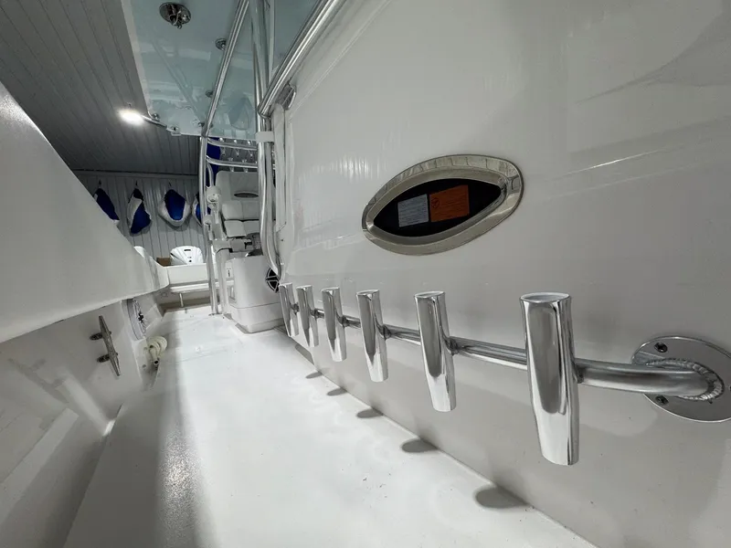 Slide: The Image of 2024 Contender 44 ST boat interior with rod holders and seating area. - 13