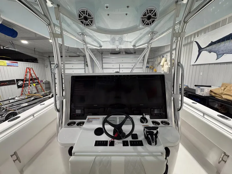 Slide: The Image of 2024 Contender 44 ST boat cockpit with advanced navigation controls and sleek design. - 16