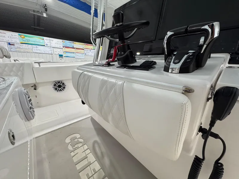 Slide: The Image of 2024 Contender 44 ST boat interior with steering wheel and controls, showcasing modern design. - 19
