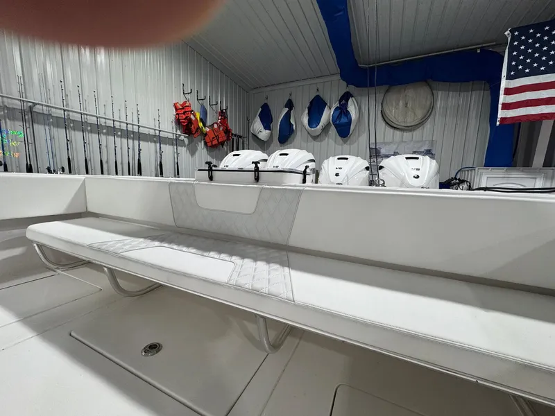 Slide: The Image of 2024 Contender 44 ST boat interior with seating, fishing rods, and American flag. - 20