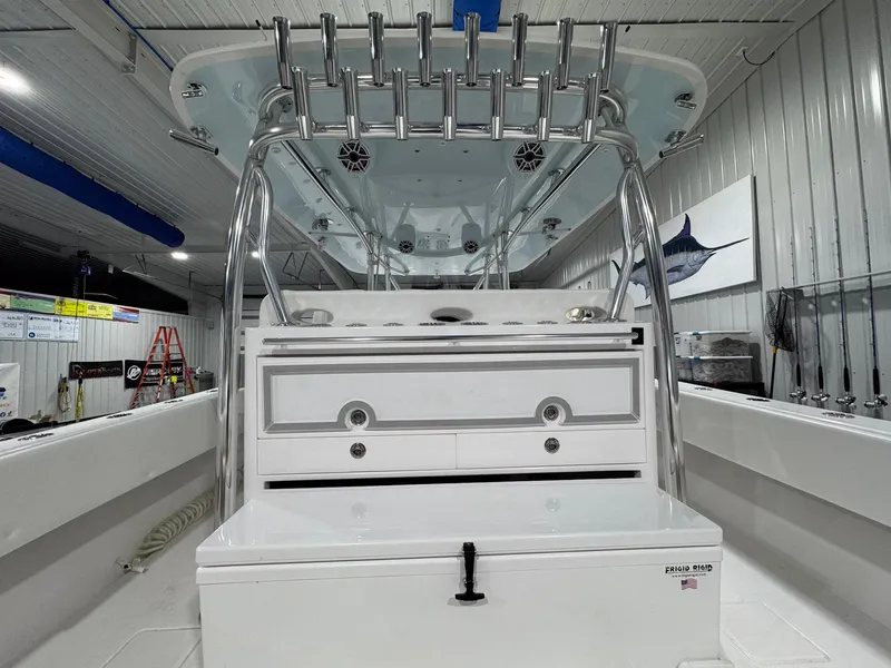 Slide: The Image of 2024 Contender 44 ST boat interior with fishing rod holders and storage compartments. - 22