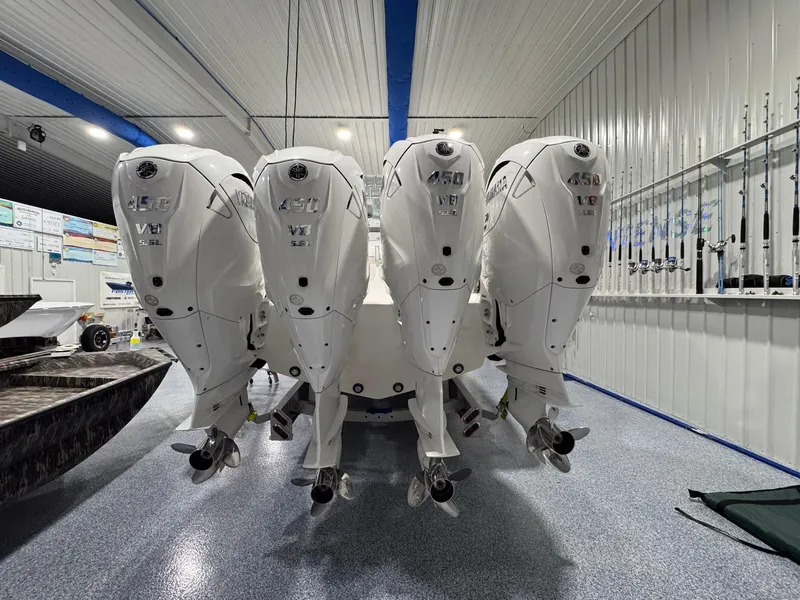 Slide: The Image of 2024 Contender 44 ST boat with four powerful 450 V8 engines in a showroom. - 3