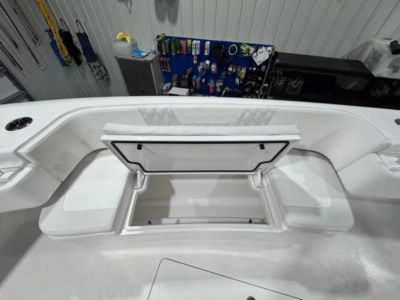Slide: The Image of 2024 Contender 44 ST boat interior with open storage compartment and fishing gear. - 31