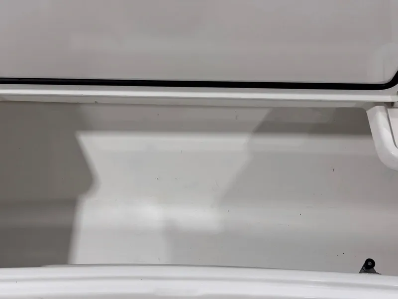 Slide: The Image of 2024 Contender 44 ST boat storage compartment, white interior, open lid. - 32