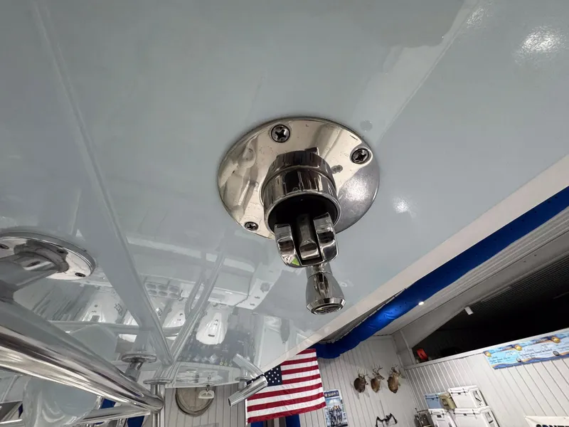 Slide: The Image of 2024 Contender 44 ST boat detail with stainless steel fitting and American flag in background. - 35