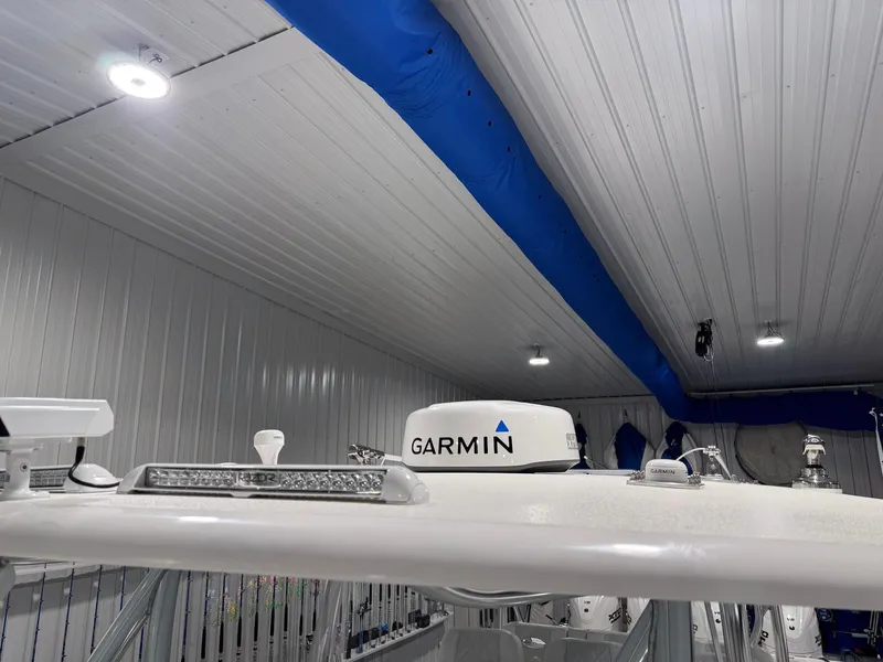 Slide: The Image of 2024 Contender 44 ST boat with Garmin equipment in a well-lit indoor setting. - 41