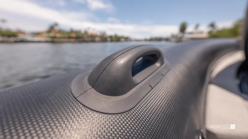 Slide: The Image of Close-up of Skipper-BSK 38NC boat handle, 2025 model, with blurred water background. - 25