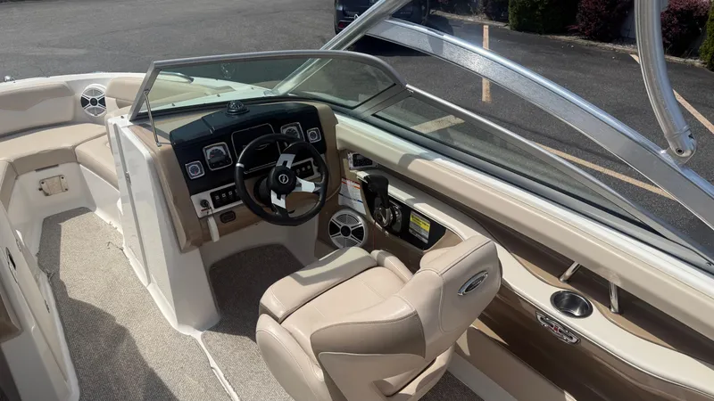 Slide: The Image of 2011 Chaparral 206 SSi boat interior with beige seating and modern dashboard. - 10