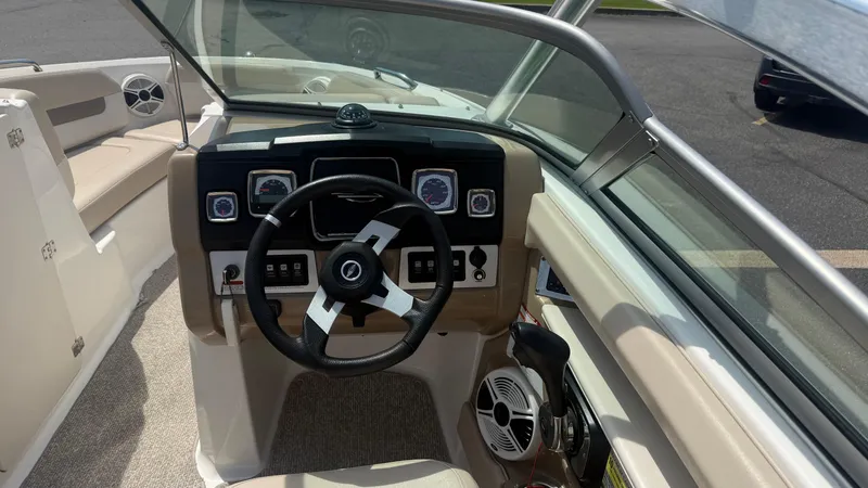 Slide: The Image of 2011 Chaparral 206 SSi boat dashboard with steering wheel and control panel. - 11