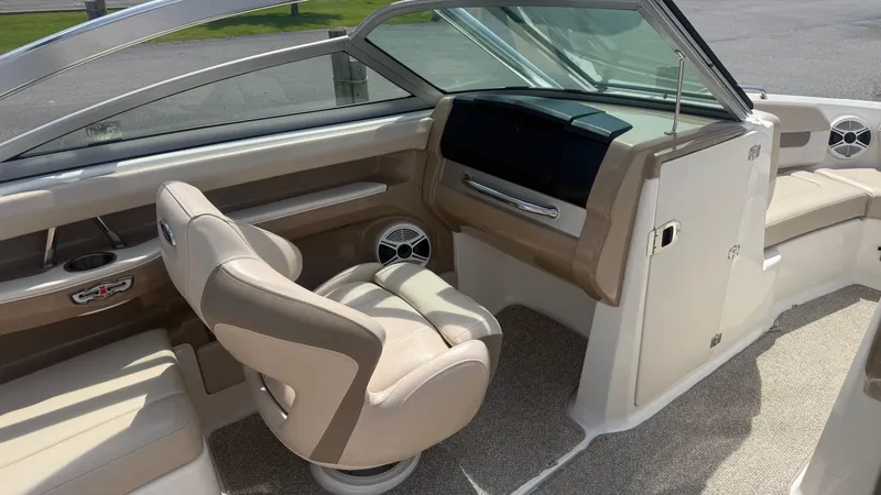 Slide: The Image of 2011 Chaparral 206 SSi boat interior with beige seating and modern dashboard design. - 12