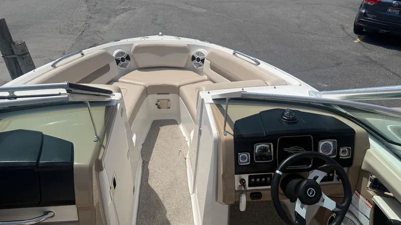 Slide: The Image of 2011 Chaparral 206 SSi boat interior with beige seating and dashboard view. - 13